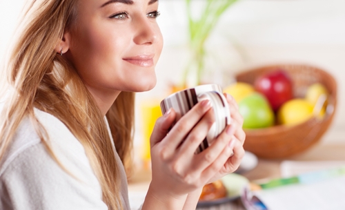 Picture of a Lady Drinking a cup of coffee