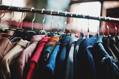 Clothes hanging on a clothes rack at a shop near The Macleay Sydney